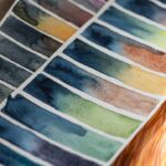 Hand-painted watercolor swatches arranged in rows of mixed colors
