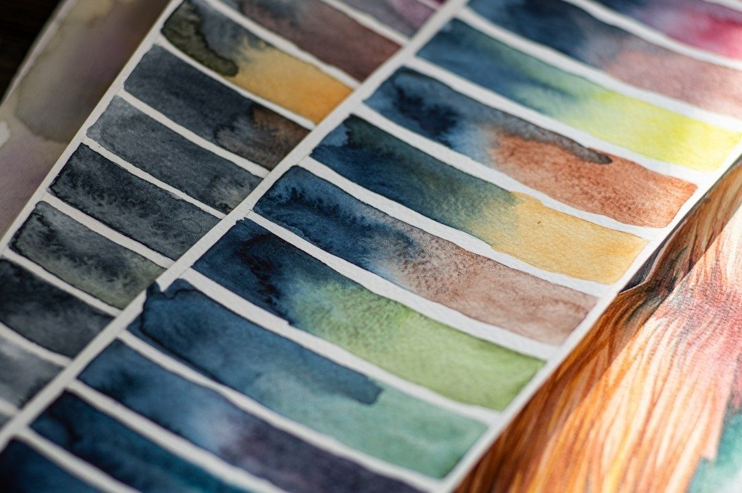 Hand-painted watercolor swatches arranged in rows of mixed colors